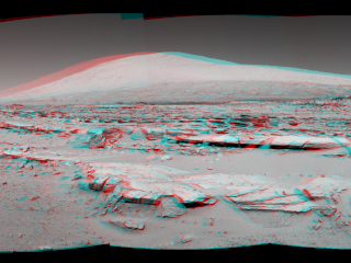 This stereo landscape scene from NASA's Curiosity Mars rover shows rows of rocks in the foreground and Mount Sharp on the horizon.