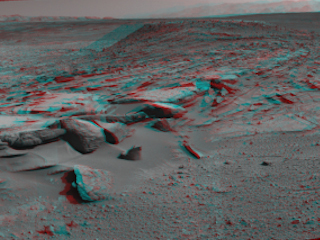 This 160-degree, stereo view from NASA's Curiosity Mars rover is centered southward toward a planned science waypoint at "the Kimberley," with an outcrop of eroded sandstone in the foreground.
