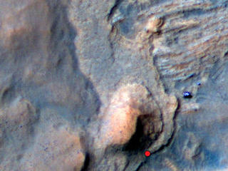 In this Mars Reconnaissance Orbiter view of the Curiosity rover mission's waypoint called "the Kimberley," the red dot indicates the location of a sandstone target, "Windjana," selected for close-up inspection. The
