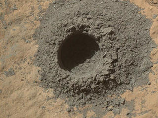 This image from Curiosity's Mars Hand Lens Imager shows the hole resulting from the test, 0.63 inch across and about 0.8 inch deep.