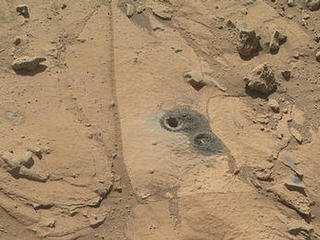 This May 12, 2014, view from the Mars Hand Lens Imager (MAHLI) in NASA's Curiosity Mars Rover shows the rock target "Windjana" and its immediate surroundings after inspection of the site by the rover by drilling and other activities.