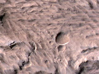 The largest crater associated with a March 2012 impact on Mars has many smaller craters around it, revealed in this image from the High Resolution Imaging Science Experiment (HiRISE) camera on NASA's Mars Reconnaissance Orbiter.