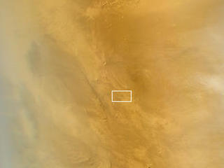 This March 20, 2014, image from the MARCI camera on NASA's Mars Reconnaissance Orbiter has a dark spot (at center of inscribed rectangle) noticed while the image was being examined for a weather report. Other observations confirmed that the spot is a scar from a space rock hitting Mars in 2012.