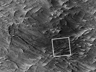 This April 6, 2014, image from the Context Camera on NASA's Mars Reconnaissance Orbiter was taken as a follow-up to discovery of a possible 2012 impact scar in images from the orbiter's Mars Color Imager. It reveals two craters within the darkened area (at center of the inscribed rectangle).