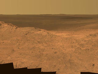 This scene from the panoramic camera (Pancam) on NASA's Mars Exploration Rover Opportunity catches "Pillinger Point," on the western rim of Endeavour Crater, in the foreground. The eastern rim of the crater is on the distant horizon. The scene merges many Pancam exposures taken on May 14, 2014.