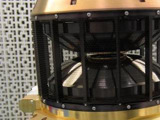 This image shows the wind analyzer instrument box that is yellow metal at the bottom, the top is a circular black cylinder.  The whole instrument is the size of a shoebox.
