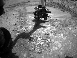 This image from the front Hazcam on NASA's Curiosity Mars rover shows the rover's drill in place during a test of whether the rock beneath it, 'Bonanza King,' would be an acceptable target for drilling to collect a sample.