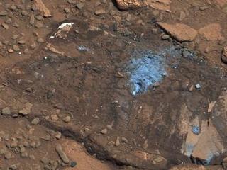 This image of Bonanza King rock, which is brown and has a lighter-blueish area in the middle where the Curiosity tapped the rock.