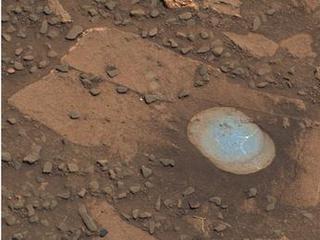 This image shows Bonanza King rock with a brown surface and in the middle is a partly drilled spot shown in lighter blue.