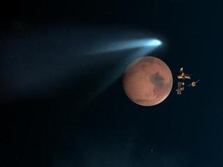 This artist's concept shows NASA's Mars orbiters lining up behind the Red Planet for their "duck and cover" maneuver to shield them fro comet dust that may result from the close flyby of comet Siding Spring (C/2013 A1) on Oct. 19, 2014.