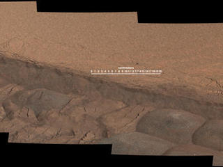 A wheel track cuts through a windblown ripple of dusty sand in this Nov. 7, 2014, image from the Mastcam on NASA's Curiosity rover. The view spans about four feet across. This experiment was planned for yielding a view of the inside of the ripple for assessment of particle sizes and composition.