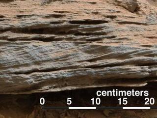 Cross-bedding seen in the layers of this Martian rock is evidence of movement of water recorded by waves or ripples of loose sediment the water passed over.