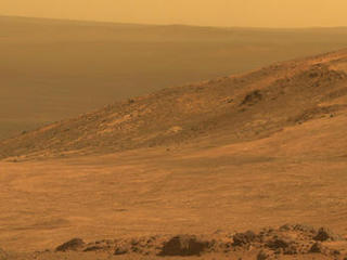 This view from NASA's Opportunity Mars rover shows part of "Marathon Valley," a destination on the western rim of Endeavour Crater, as seen from an overlook north of the valley. It was taken by the rover's Pancam on March 13, 2015. This version is in approximate true color.