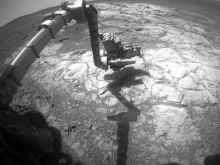 NASA's Mars Exploration Rover Opportunity has extended its robotic arm for studying a light-toned rock target called "Athens" in this March 25, 2015, image from the rover's front hazard avoidance camera.