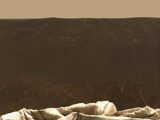 This expansive view of the martian real estate surrounding the Mars Exploration Rover Opportunity is the first 360 degree, high-resolution color image taken by the rover's panoramic camera.