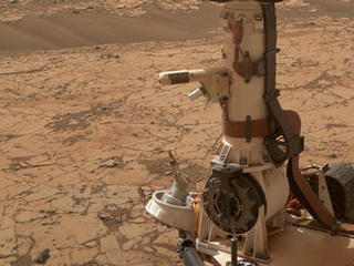 The Rover Environmental Monitoring Station (REMS) on NASA's Curiosity Mars rover includes temperature and humidity sensors mounted on the rover's mast. One of the REMS booms extends to the left from the mast in this view.