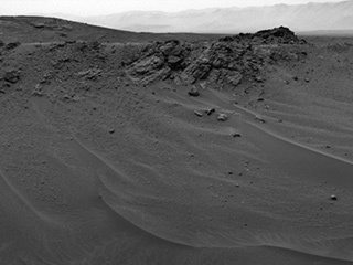 NASA's Curiosity Mars rover used its Navigation Camera (Navcam) to capture this scene toward the west just after completing a drive that took the mission's total driving distance past 10 kilometers (6.214 miles).