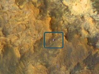 A view from NASA's Mars Reconnaissance Orbiter on April 8, 2015, catches sight of NASA's Curiosity Mars rover passing through a valley called "Artist's Drive" on the lower slope of Mount Sharp.