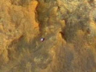 A view from NASA's Mars Reconnaissance Orbiter on April 8, 2015, catches sight of NASA's Curiosity Mars rover passing through a valley called "Artist's Drive" on the lower slope of Mount Sharp.