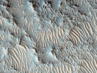 Wispy pink dunes are shown in this image of Mars.