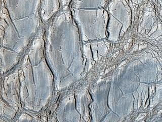 With its cracked, blistery appearance, this mound near the center of a very large, over 5-kilometer diameter mid-latitude crater poses an interesting question: how did this form?
