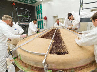 In this February 2015 scene from a clean room at Lockheed Martin Space Systems, Denver, specialists are building the heat shield to protect NASA's InSight spacecraft when it is speeding through the Martian atmosphere.