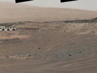 This May 10, 2015, view from Curiosity's Mastcam shows terrain judged difficult for traversing between the rover and an outcrop in the middle distance where a pale rock unit meets a darker rock unit above it. The rover team decided not to approach this outcrop and identified an alternative.