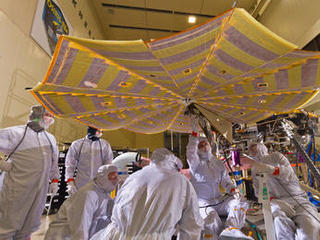 Engineers and technicians at Lockheed Martin Space Systems, Denver, run a test of deploying the solar arrays on NASA's InSight lander in this April 30, 2015 image.