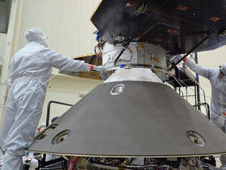 Spacecraft specialists at Lockheed Martin Space Systems, Denver, are preparing to attach the cruise stage of NASA's InSight spacecraft to the top of the spacecraft's back shell in this April 29, 2015, photo.