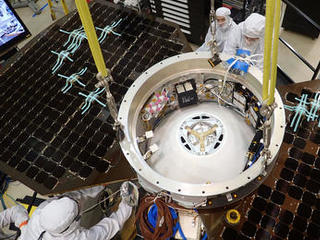 This photo shows the upper side of the cruise stage of NASA's InSight spacecraft as specialists at Lockheed Martin Space Systems, Denver, attach it to the spacecraft's back shell.