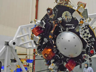 The science deck of NASA's InSight lander is being turned over in this April 29, 2015, photo from InSight assembly and testing operations inside a clean room at Lockheed Martin Space Systems, Denver.