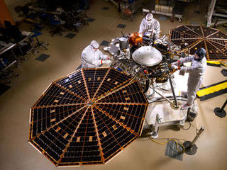 The solar arrays on NASA's InSight lander are deployed in this test inside a clean room at Lockheed Martin Space Systems, Denver.