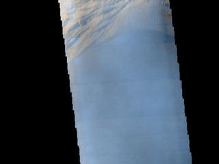 Seen shortly after local Martian sunrise, clouds gather in the summit pit, or caldera, of Arsia Mons, a giant volcano on Mars, in this image from the Thermal Emission Imaging System (THEMIS) on NASA's Mars Odyssey orbiter.
