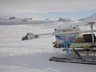 Photograph showing the prototype RIMFAX antenna attached to a snowmobile during tests in Svalbard, Norway.