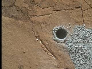 NASA's Curiosity Mars Rover drilled this hole to collect sample material from a rock target called "Buckskin" on July 30, 2015, about a week prior to the third anniversary of the rover's landing on Mars. The diameter is slightly smaller than a U.S. dime.