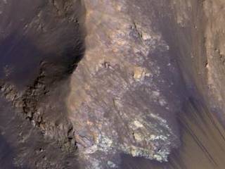 Among the many discoveries by NASA's Mars Reconnaissance Orbiter since the mission was launched on Aug. 12, 2005, are seasonal flows on some steep slopes, possibly shallow seeps of salty water. This July 21, 2015, image from the orbiter's HiRISE camera shows examples within Mars' Valles Marineris.