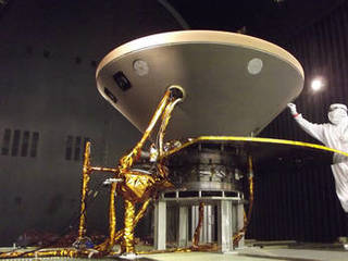 In this photo, a spacecraft specialist prepares NASA's InSight spacecraft for thermal vacuum testing in the flight system's "cruise" configuration for its 2016 flight to Mars.