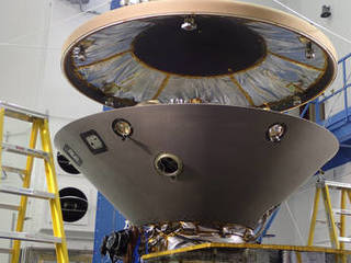 The heat shield is suspended above the rest of the InSight spacecraft in this image taken July 13, 2015, in a spacecraft assembly clean room at Lockheed Martin Space Systems, Denver.