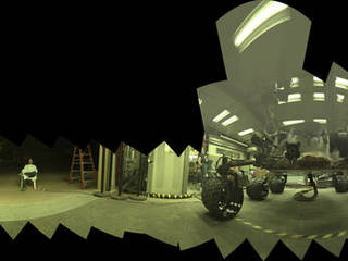 This view of a test rover at NASA's Jet Propulsion Laboratory in California results from advance testing of arm positions and camera pointings for taking a low-angle selfie of NASA's Curiosity Mars rover. The rehearsal led to a dramatic Aug. 5, 2013, selfie of Curiosity by the rover's MAHLI camera.