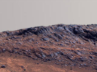 This Martian scene shows contrasting textures and colors of "Hinners Point," at the northern edge of "Marathon Valley," and swirling reddish zones on the valley floor to the left.