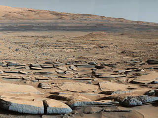 A view from the "Kimberley" formation on Mars taken by NASA's Curiosity rover. The strata in the foreground dip towards the base of Mount Sharp, indicating the ancient depression that existed before the larger bulk of the mountain formed.