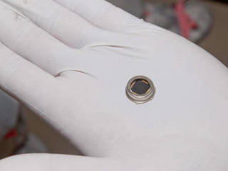 The dime-size microchip in this close-up image carries 826,923 names that will go to Mars on NASA's InSight lander.