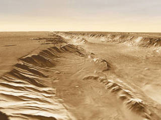 A small basin (center foreground) lies below the southern rim of Melas Chasma, part of Valles Marineris.