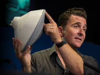 Adam Steltzner of JPL holds up a model of a Mars entry capsule.