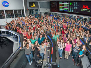 Women working in science, technology, engineering and mathematics at NASA's Jet Propulsion Laboratory pose for a photo in mission control in honor of Women in Science Day.
