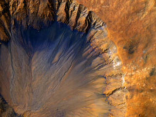 This impact crater appears relatively recent as it has a sharp rim and well-preserved ejecta, the material thrown out of the crater when a meteorite hit Mars.
