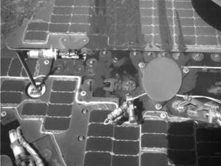 This March 21, 2016, image from the navigation camera on NASA's Mars rover Opportunity shows streaks of dust or sand on the vehicle's rear solar panel after a series of drives during which the rover was pointed steeply uphill. The tilt and jostling of the drives affected material on the rover deck.