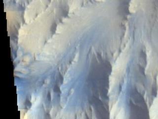 Morning clouds fill Coprates Chasma on Mars in this Nov. 25, 2015, image from the THEMIS camera on NASA's Mars Odyssey. No orbiter systematically observed Mars in morning sunlight before 2015. The clouds appear blue because ice particles in them scatter blue light more strongly than other colors.