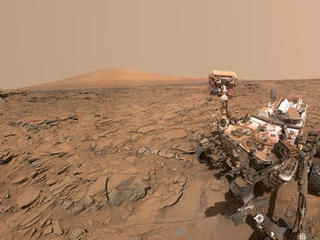 The top of the rover's mast faces away in this May 11, 2016, self-portrait of NASA's Curiosity Mars rover, which shows the vehicle at the "Okoruso" drilling site on lower Mount Sharp. The scene is a mosaic of multiple images taken with the arm-mounted Mars Hands Lens Imager (MAHLI).
