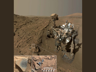 This scene shows NASA's Curiosity Mars rover at a location called "Windjana," where the rover found rocks containing manganese-oxide minerals, which require abundant water and strongly oxidizing conditions to form.